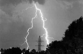 Figure 3-6 Lightning Causes EMP Damage Remotely: lighting strikes in the distance behind power lines