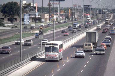 Figure 2: This photo shows a Houston METRO bus operating in the North (I-45N) Freeway contraflow lane.  The contraflow lane is separated from the adjacent freeway lane by plastic pylons inserted in the freeway.  This figure shows the general design and operation of the I-45N contraflow lane.