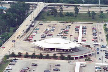 Figure 8: This photo illustrates the direct access ramp and transit station located at the Kuykendahl park-and-ride lot in Houston.  The direct access ramp is an elevated structure connecting the HOV lane in the freeway median with the park-and-ride lot.  This figure helps the reader understand the design and operation of the direct access ramps to park-and-ride lots associated with HOV lanes.