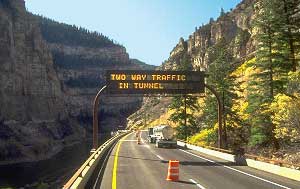 Figure 2-2 Interstate 70, Glenwood Canyon, Colorado: a Variable Message Sign positioned before the entrance to a tunnel displays the message: Two Way Traffic In Tunnel