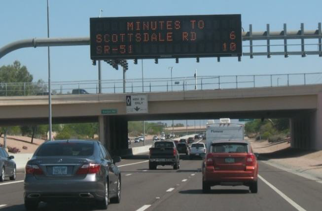 Figure 14. An image of an interstate with an overhead sign that reads: Minutes to  Scottsdale Rd - 6, SR-51 - 10