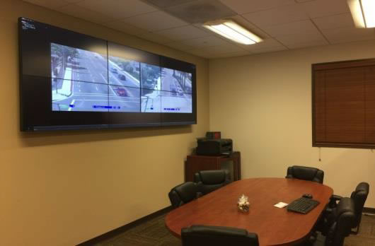Image of meeting room with TV screen with roadways displayed.