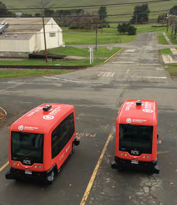 Image of two red SAV shuttles testing on road at GoMentum Station, Concord CA.