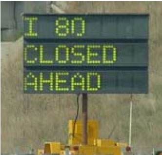 Mobile sign that reads 'I 80 Closed Ahead'.