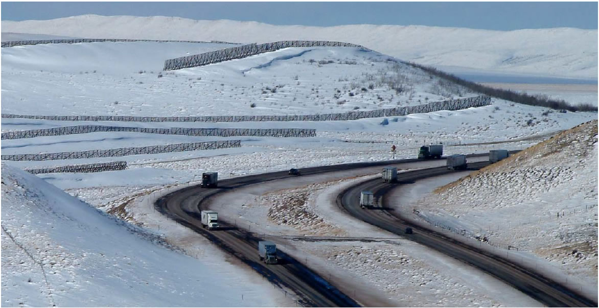 Picture of Interstate 80 in a snowy landscape with freight trucks on the road.