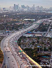Photo. Aerial view of a Miami roadway with vehicles using toll lanes and general purpose lanes.  The toll lanes are less congested.
