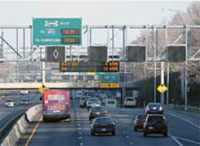 Photo. Overhead signs identifying upcoming toll lanes and current toll amounts along I-35W in Minneapolis, Minnesota.
