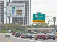 Photo. Overhead signs identifying upcoming toll lanes and current toll amounts along I-394 in Minneapolis, Minnesota.
