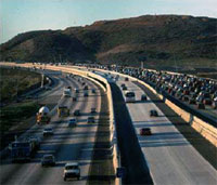 Photo. View of a San Diego roadway with vehicles using the toll lanes and the general purpose lanes.  The toll lane is less congested.