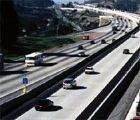Photo. View of a San Diego roadway with vehicles using the toll lanes and the general purpose lanes.