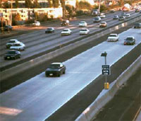 Photo. View of a San Diego roadway with vehicles using the toll lanes and the general purpose lanes.