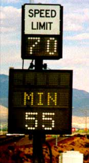 photo of a variable speed limit sign, displaying "SPEED LIMIT 70" above an additional message sign displaying "MIN 55"