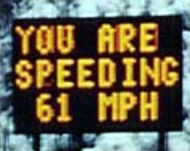 photo of a speed warning sign displaying the message "YOU ARE SPEEDING 61 MPH"