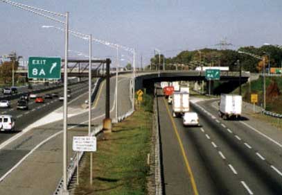 photo of a section of the New Jersey Turnpike, with one set of lanes (inner roadway) reserved for cars only and another set of lanes (outer roadway) for both cars and trucks. These sections are separated by medians and/or concrete barriers. This configuration is used for both directions of travel