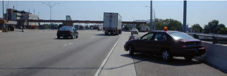 Photo of U.S. toll plaza, with a truck and cars entering the OB-1 collection station.