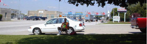 Photo of Canadian toll booths from IB-1 collection station, showing vehicles entering inspection booths.