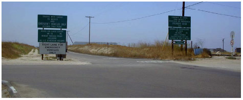 A photo of the OB-1 data collection location, facing south toward the Mexican border. Information signs are shown on both sides of the entrance.