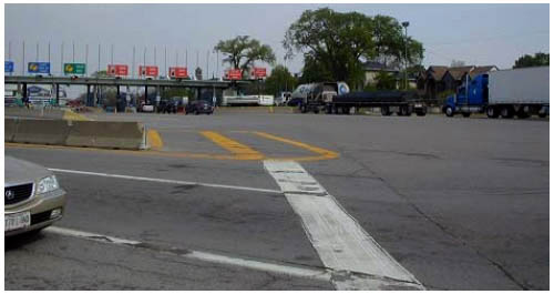 Photo of U.S. toll booths at the Peace Bridge crossing, showing vehicles in line at the booths.
