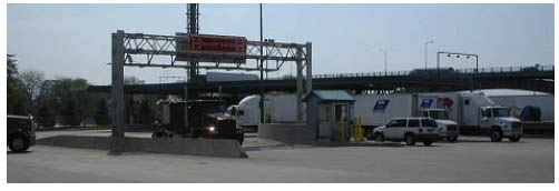Photo of Canadian Customs primary inspection booths, showing trucks going through the OB-2 collection location.