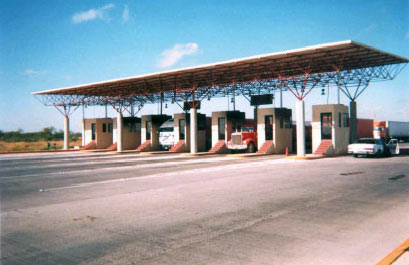 Photo of inbound access booths in Nuevo Laredo, showing vehicles in the inspection booths.