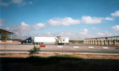 Photo of outbound import booths in Nuevo Laredo, showing a side view of a truck exiting the booths.