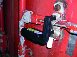 Photo of an electronic seal on the handle and lock of a container door.