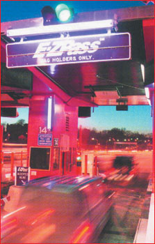 Image of a toll booth that electronically scans a tag affixed to a motor vehicle's windshield and deducts tolls from a prepaid account.  The advantage of this system is that drivers do not have to stop.