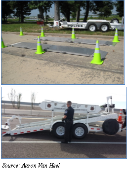 Photo of area setup to use the semi-portable scales. The semi-portable scales are laid out, lined with neon green cones, ready for use (top). Photo of trailer used to transport the semi-portable scales (bottom). Source Aaron Van Heel.