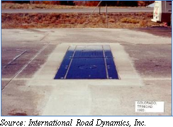 Photograph of blue plates covering a Single Load Cell WIM system in the road. Source: International Road Dynamics, Inc.