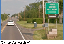 Street view photo of sign informing drivers of the location of the weigh station on the next right. Source: Google Earth.