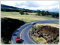 cars on winding rural road