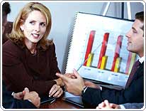 people talk in front of a bar graph chart