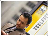 man stands in front of bus stop sign