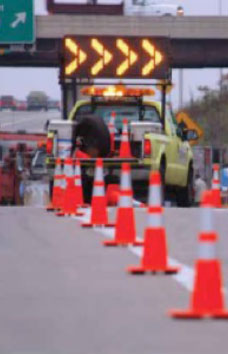 Figure 16: Photo: Roadway with restricted lane indicated by traffic cones and signaling truck.