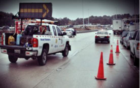 Figure 17: Photo: Roadway with restricted lane (due to an incident) indicated by traffic cones and signaling incident response truck.