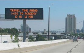 Figure 25: Photo: Roadway dynamic message sign billboard showing mileage and travel time to a downstream interchange with dynamic traffic instructions.