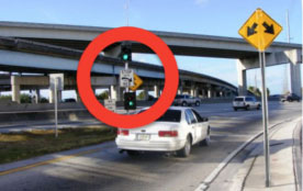 Figure 26: Photo: Automobile about to enter freeway at a metered ramp, and responding to a green light on ramp signal (circled in red).