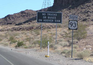 A highway sign next to U.S. 93 is shown. The sign states that trucks and buses are not allowed on the Hoover Dam. 
