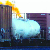 Photograph of tanker railcar leaking orange plume