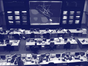Photograph of desks and monitoring system in an operations center.