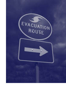 Photograph of an evacuation route sign indicating direction of travel for evacuation.
