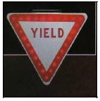 Photograph of an illuminated Yield sign.