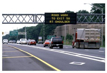 Photograph of a changeable message sign warning travelers of a work zone ahead.