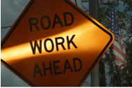 A construction “Road Work Ahead” sign.