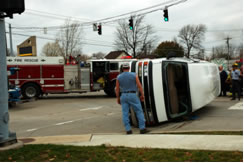 Image showing a rolled over van with fire department responding.