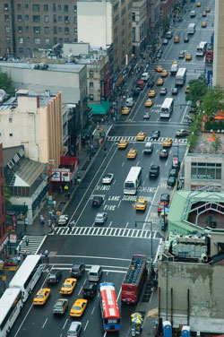 Photo. Birds-eye view of urban street with moderate traffic flow.