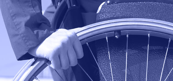Close up of a woman's hand on a wheelchair's wheel