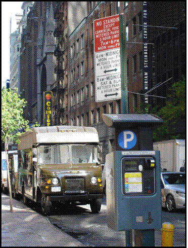 Figure 3 is a photo of a New York City Muni-meter and includes several cars and delivery vehicles parked along the curb.