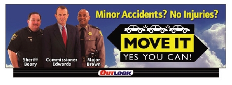 Photo of a billboard featuring Sheriff Beary, Commissioner Edwards, and Major Brown that reads "Minor Accidents? No Injuries? MOVE IT. YES YOU CAN!"