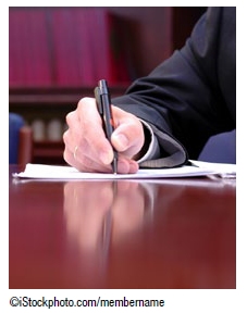 Photo of a hand writing on a piece of paper. Copyright iStockphoto.com/membername